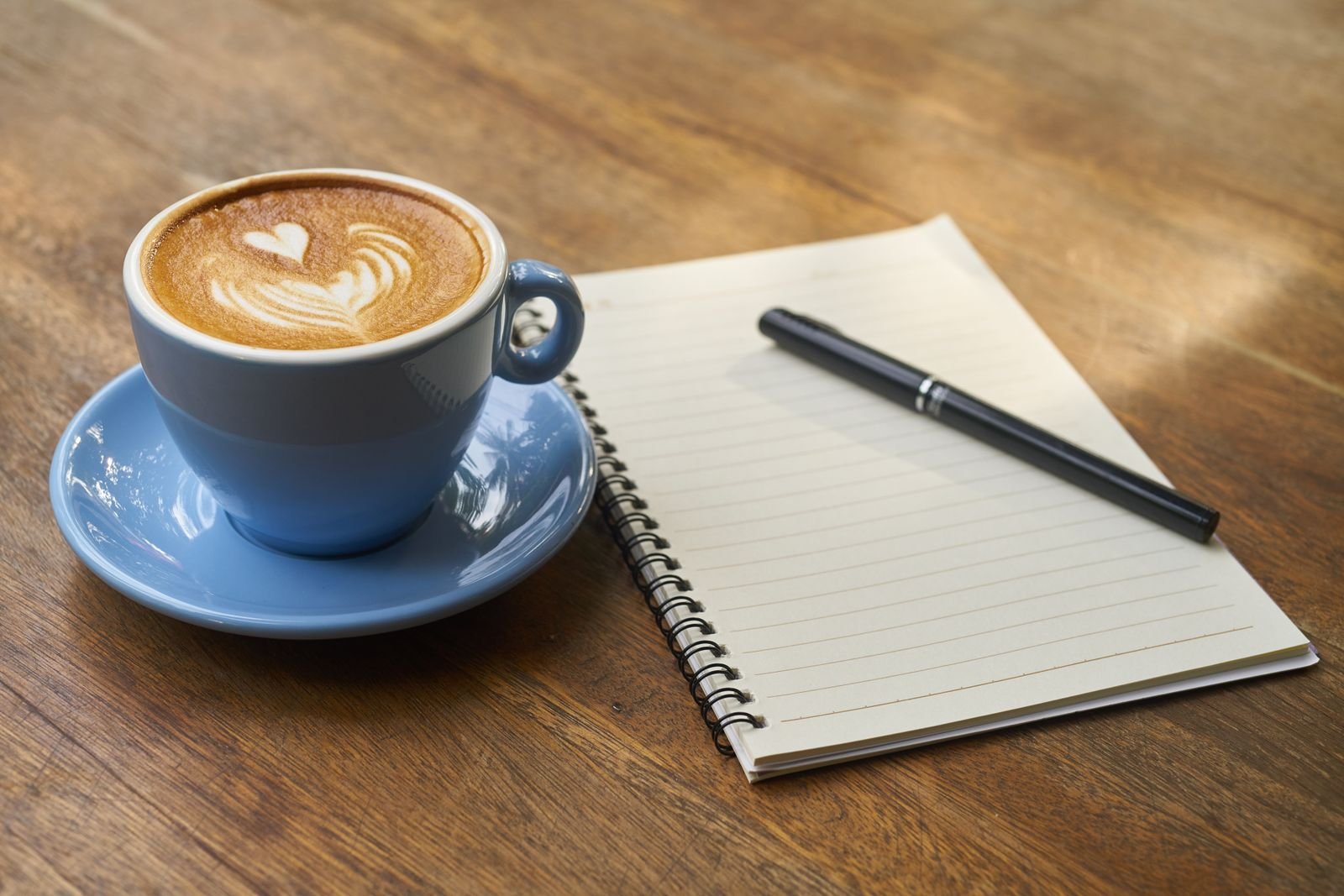 Notebook and coffee on a table