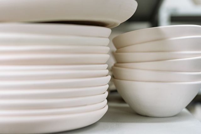 Stacked white plates and bowls